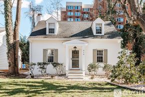 Charlottesville apartment for rent - A white house with a black roof and a brown door.