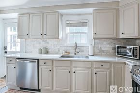 Charlottesville apartment for rent - A kitchen with white cabinets and a stainless steel dishwasher.
