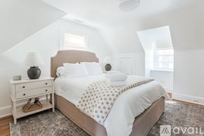 Charlottesville apartment for rent - A bedroom with a bed, nightstand, and lamp.