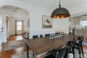 Charlottesville apartment for rent - A dining room with a wooden table and chairs.