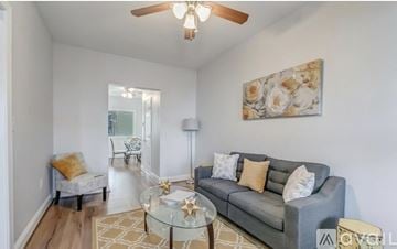 Washington townhouse for rent - A living room with a grey couch, a glass table, and a painting on the wall.