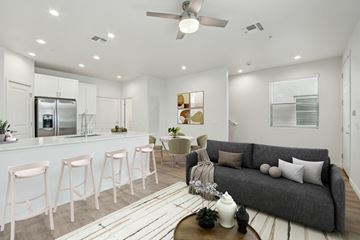 Glendale apartment for rent - A modern living room with a grey couch and a bar area.