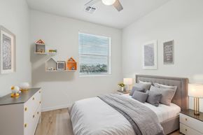 Glendale apartment for rent - A bedroom with a bed, nightstand, and a dresser with decorative items on top.