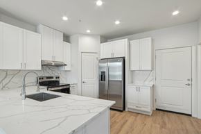 Glendale apartment for rent - A kitchen with white cabinets and a marble countertop.