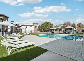 Glendale apartment for rent - A pool with sun loungers in front of a building.