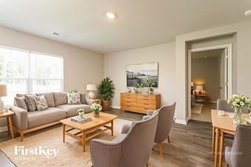 Lexington house for rent - A well-lit living room with a grey sofa, wooden coffee table, and a painting on the wall.