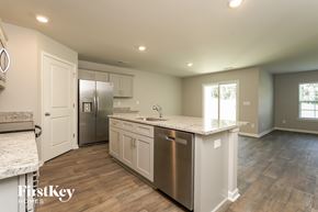 Lexington house for rent - A kitchen with a stainless steel dishwasher and white cabinets.