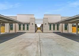 Weslaco apartment for rent - A building with a yellow door in the center.