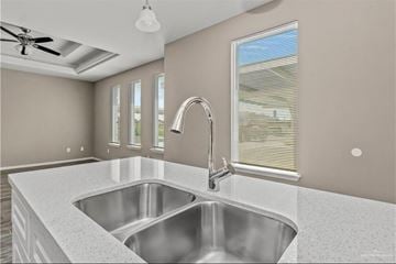 Weslaco apartment for rent - A modern kitchen with a stainless steel sink and a ceiling fan.