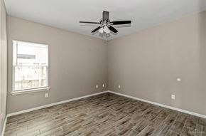 Weslaco apartment for rent - A room with a ceiling fan and a window.