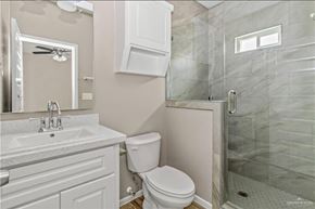Weslaco apartment for rent - A bathroom with a toilet, sink, and shower.