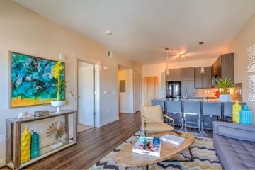 Sandy apartment for rent - A modern living room with a wooden floor and a large painting on the wall.