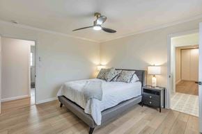 Santa Clara house for rent - A bedroom with a bed, nightstand, and a ceiling fan.