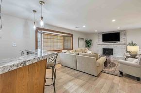 Santa Clara house for rent - A modern living room with a fireplace and a TV above it.