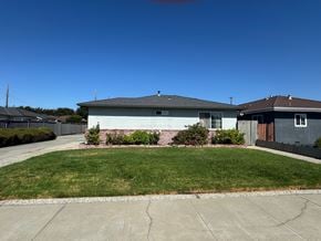 Santa Clara house for rent - A house with a grey roof and a green lawn in front.