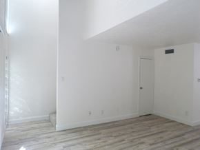 Dallas apartment for rent - A room with white walls and a wooden floor.