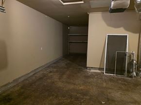 Dallas house for rent - A room with a brown floor and a white wall with a door and a window.