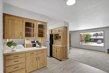 Spokane Valley house for rent - A kitchen with wooden cabinets and appliances.