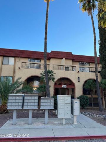 Tucson house for rent - A building with a red roof and palm trees in front.