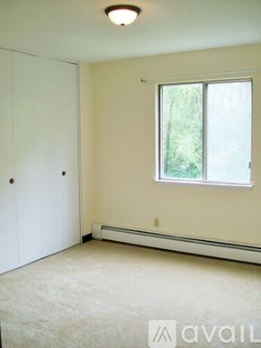 Coon Rapids apartment for rent - A room with a window and a white door.