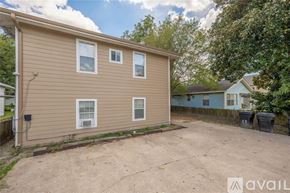 Houston apartment for rent - A beige house with a brown roof and a brown fence.