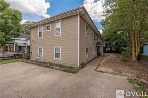 Houston apartment for rent - A beige house with a driveway in front of it.