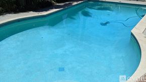 Los Angeles house for rent - A small empty swimming pool with a blue tiled edge.