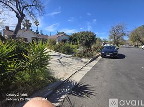 Los Angeles house for rent - A house with a car parked in front of it.