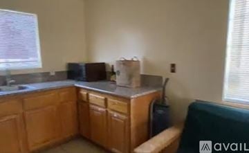 Rosemead house for rent - A kitchen with wooden cabinets and a countertop.