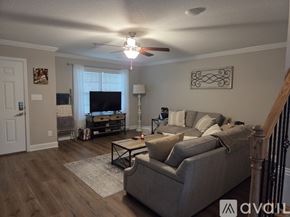 Knoxville house for rent - A spacious living room with a staircase leading to the upper floor.