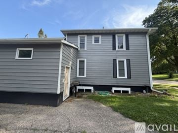 Owatonna apartment for rent - A kitchen with a white dishwasher and brown cabinets.