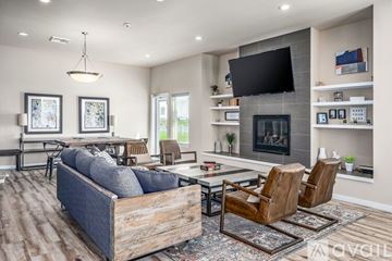 Airway Heights apartment for rent - A modern living room with a grey sofa, a wooden coffee table, and a fireplace.