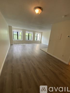 Boston apartment for rent - A room with wooden floors and a window.