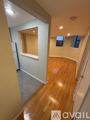 Boston apartment for rent - A hallway with wooden floors and a mirror on the wall.