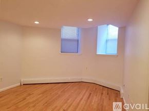 Boston apartment for rent - A room with wooden flooring and two windows.