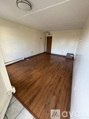 Boston apartment for rent - A room with wooden flooring and a door in the background.
