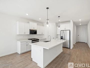 San Tan Valley house for rent - A modern kitchen with white cabinets and a central island.