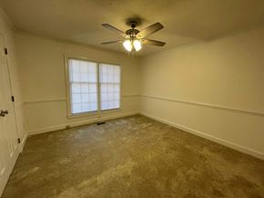 Wilson apartment for rent - A room with a ceiling fan and a window.