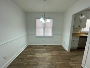 Wilson apartment for rent - A room with wooden flooring and a window with blinds.