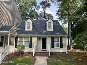 Wilson apartment for rent - A small house with a black roof and white trim.