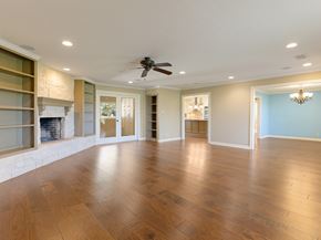 Bay City house for rent - A spacious room with wooden floors and a ceiling fan.