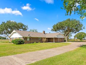 Bay City house for rent - A house with a driveway and trees in the background.