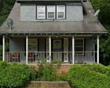 Cleveland house for rent - A house with a grey roof and white porch.