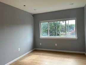 Washington apartment for rent - A room with a large window and wooden flooring.