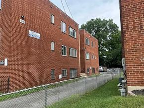 Washington apartment for rent - A red brick building with a sign that says "Bank of America.".
