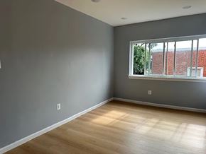 Washington apartment for rent - A room with a window and wooden flooring.