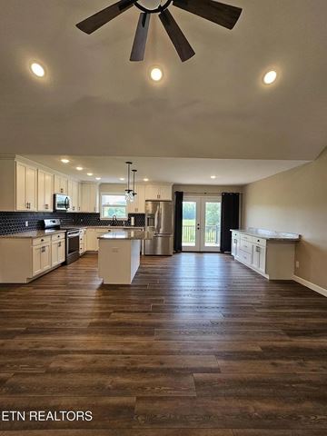 Madisonville house for rent - A spacious kitchen with a fan and wooden flooring.