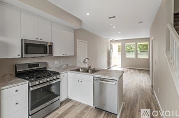 Santa Rosa house for rent - A modern kitchen with white cabinets and stainless steel appliances.