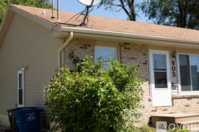 Des Moines house for rent - A house with a blue trash bin in front of it.