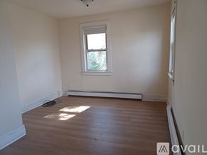 Congers house for rent - A room with a window and a wooden floor.